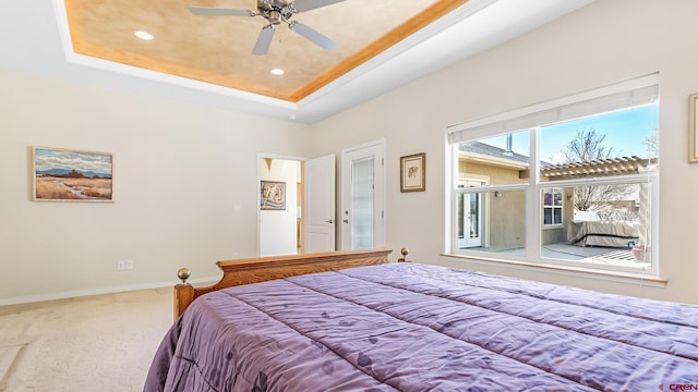 carpeted bedroom featuring recessed lighting, ceiling fan, baseboards, and a raised ceiling