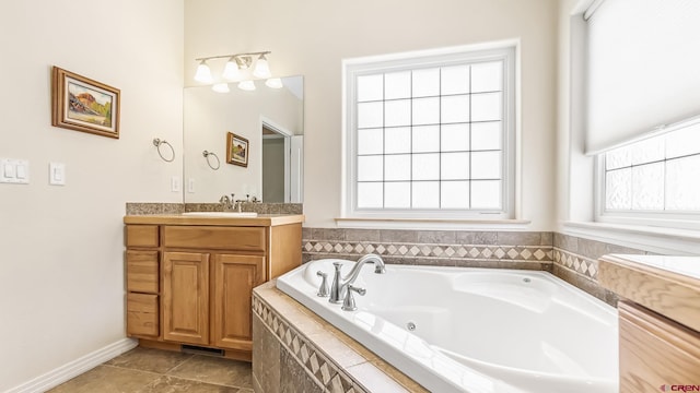 full bathroom with vanity, a tub with jets, and tile patterned flooring