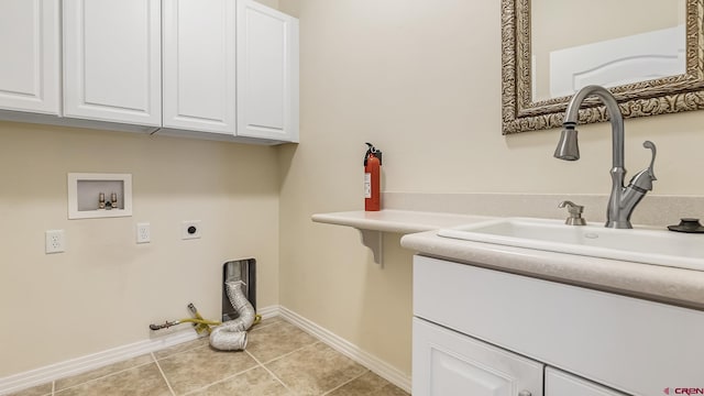 clothes washing area featuring electric dryer hookup, light tile patterned floors, hookup for a gas dryer, hookup for a washing machine, and cabinet space