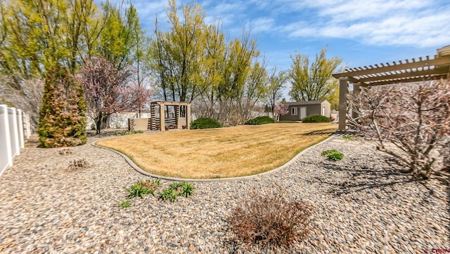 view of yard featuring a pergola and fence