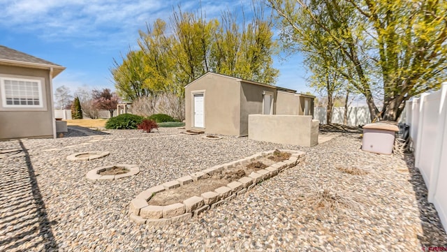 view of yard with an outbuilding, a fenced backyard, and a shed