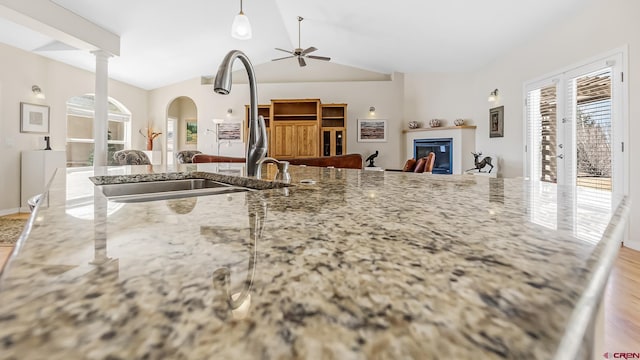 kitchen featuring open floor plan, ceiling fan, vaulted ceiling, and plenty of natural light