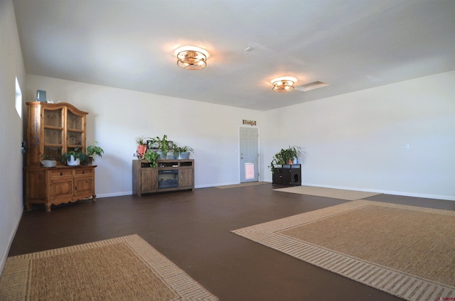 interior space with baseboards and concrete flooring