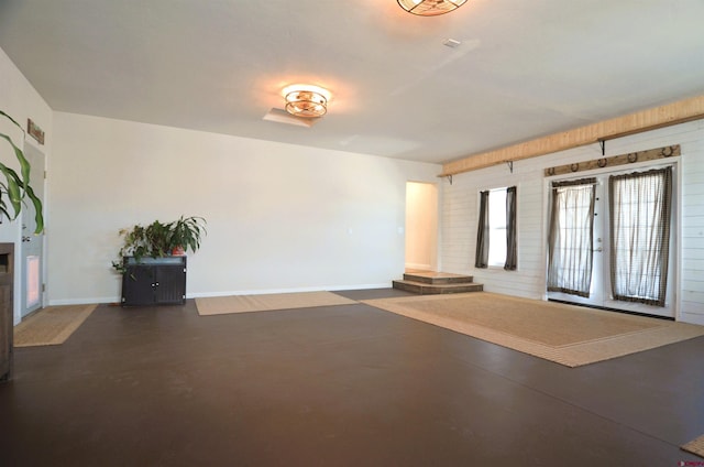 interior space with baseboards, finished concrete flooring, and a fireplace