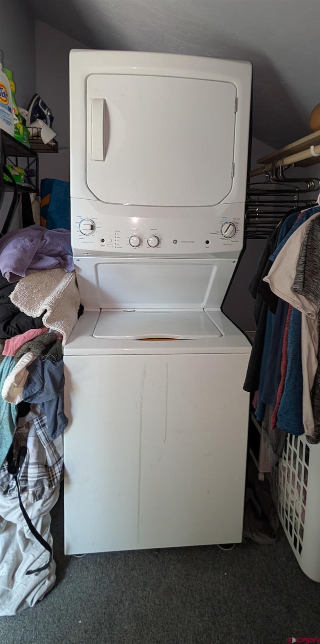 407 Simmons Dr, Pagosa Springs, CO 81147 - clothes washing area with stacked washing maching and dryer, carpet flooring, and laundry area