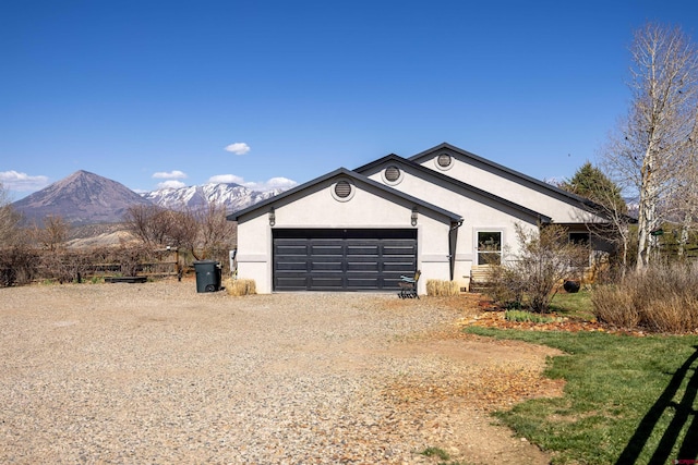 37835 Fruitland Mesa Dr, Crawford, CO 81415 - view of property exterior featuring a mountain view, stucco siding, a garage, and dirt driveway