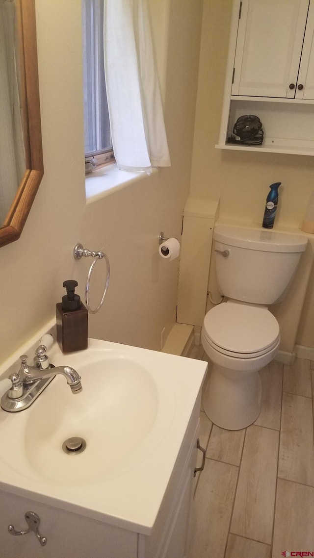 half bath featuring toilet and vanity
