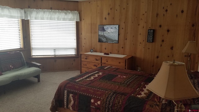 bedroom with carpet flooring and wooden walls