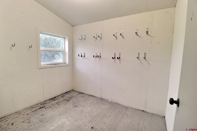 unfurnished room featuring lofted ceiling