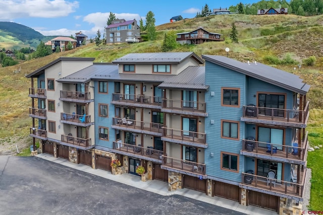 view of property with a garage and a mountain view