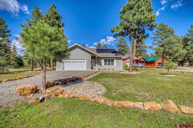 80 Cleek Ct, Pagosa Springs, CO 81147 - view of front of property with a front yard, an attached garage, solar panels, and gravel driveway