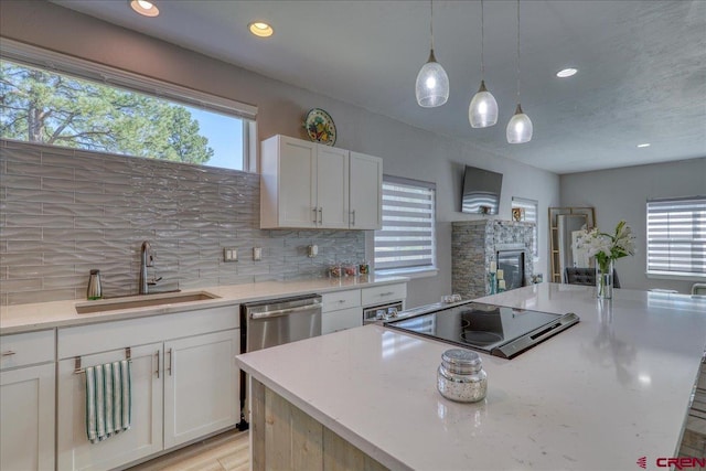 80 Cleek Ct, Pagosa Springs, CO 81147 - kitchen featuring tasteful backsplash, a center island, a sink, and a healthy amount of sunlight