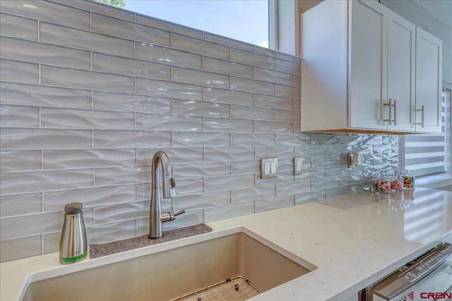 80 Cleek Ct, Pagosa Springs, CO 81147 - kitchen with decorative backsplash, a sink, and light stone countertops