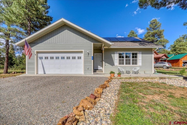 80 Cleek Ct, Pagosa Springs, CO 81147 - ranch-style home with an attached garage, solar panels, and driveway
