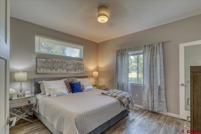 80 Cleek Ct, Pagosa Springs, CO 81147 - bedroom featuring baseboards, multiple windows, and wood finished floors