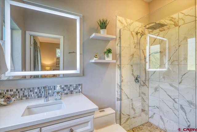 80 Cleek Ct, Pagosa Springs, CO 81147 - bathroom featuring toilet, a tile shower, tasteful backsplash, and vanity