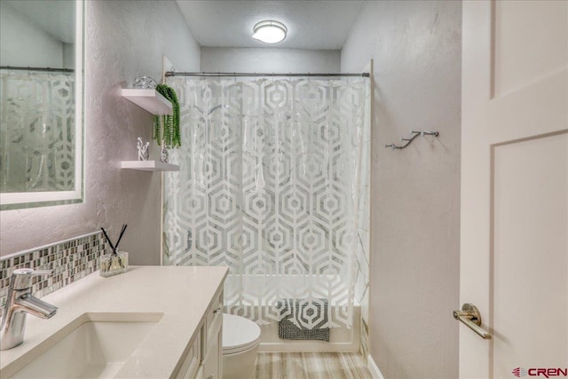 80 Cleek Ct, Pagosa Springs, CO 81147 - bathroom featuring tasteful backsplash, vanity, toilet, a shower with shower curtain, and a textured wall