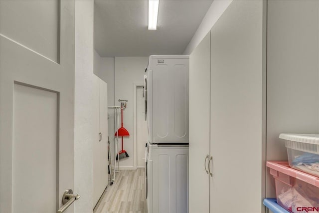 80 Cleek Ct, Pagosa Springs, CO 81147 - laundry area featuring light wood-style floors, stacked washer and clothes dryer, and laundry area