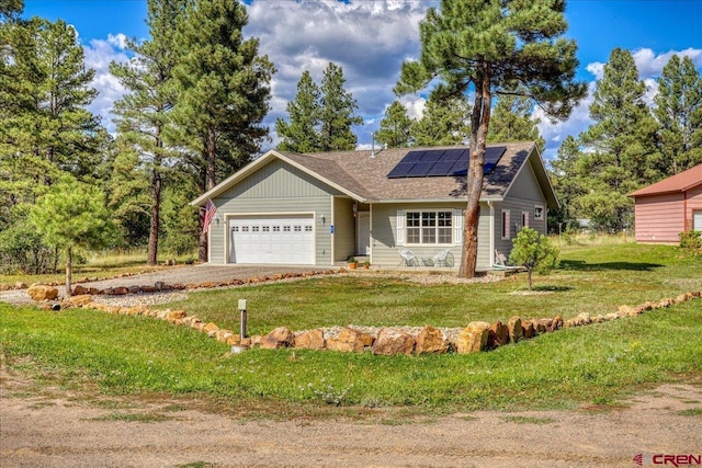 80 Cleek Ct, Pagosa Springs, CO 81147 - single story home with roof with shingles, driveway, an attached garage, a front yard, and solar panels