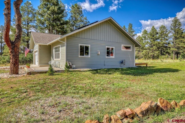 80 Cleek Ct, Pagosa Springs, CO 81147 - view of side of home featuring a patio area and a lawn