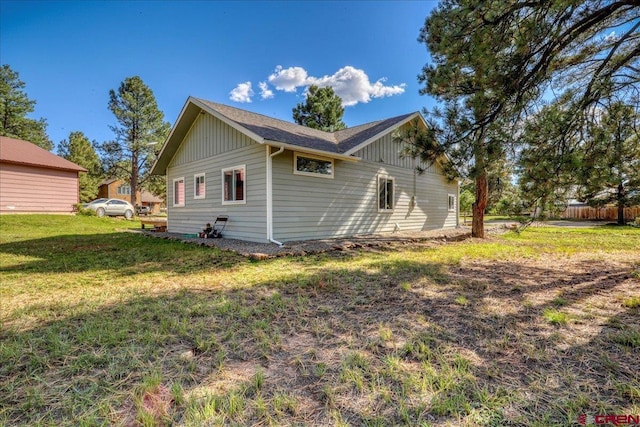 80 Cleek Ct, Pagosa Springs, CO 81147 - rear view of house featuring board and batten siding and a lawn