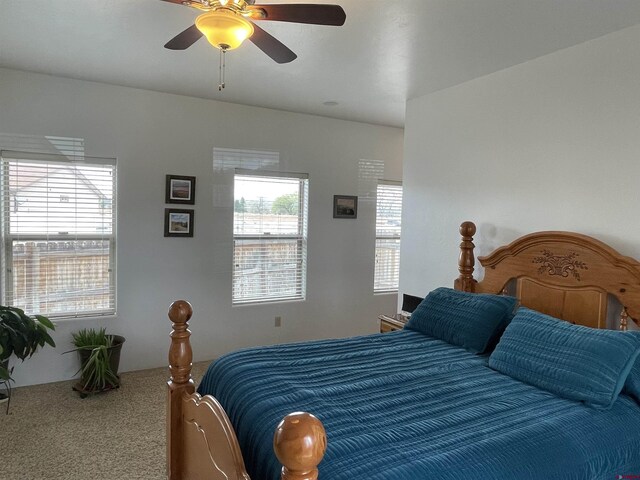 bedroom featuring ceiling fan and carpet