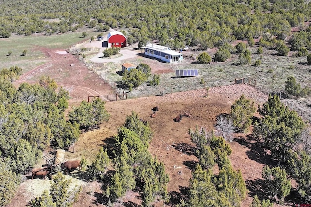 drone / aerial view featuring a forest view