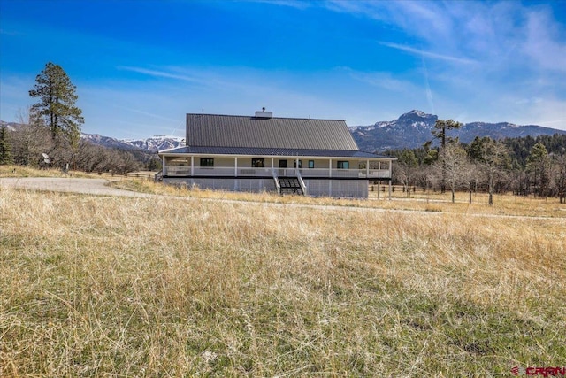 1051 Needles View Pl, Pagosa Springs, CO 81147 - rear view of property with a mountain view, a chimney, and metal roof