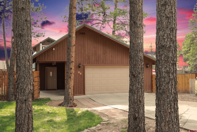 85 Dayspring Pl, Pagosa Springs, CO 81147 - view of front facade featuring concrete driveway, a garage, and fence