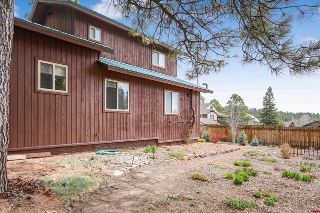 85 Dayspring Pl, Pagosa Springs, CO 81147 - view of side of home with metal roof and fence