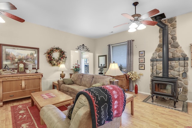 85 Dayspring Pl, Pagosa Springs, CO 81147 - living area featuring light wood finished floors, a wood stove, and a ceiling fan
