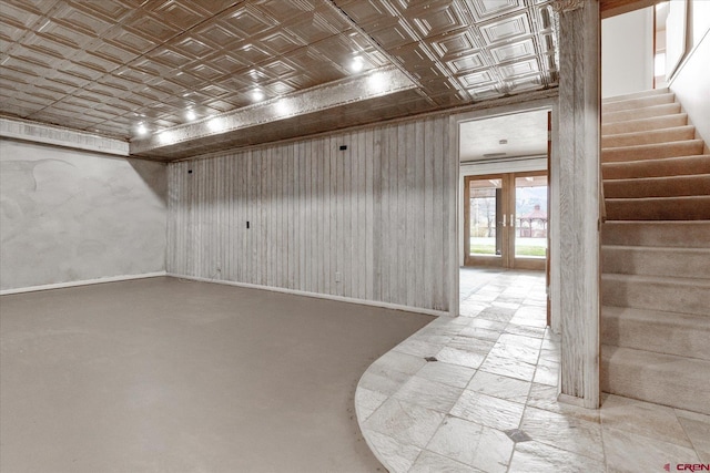 interior space featuring baseboards, an ornate ceiling, french doors, and stairs