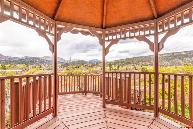 wooden terrace featuring a gazebo and a mountain view