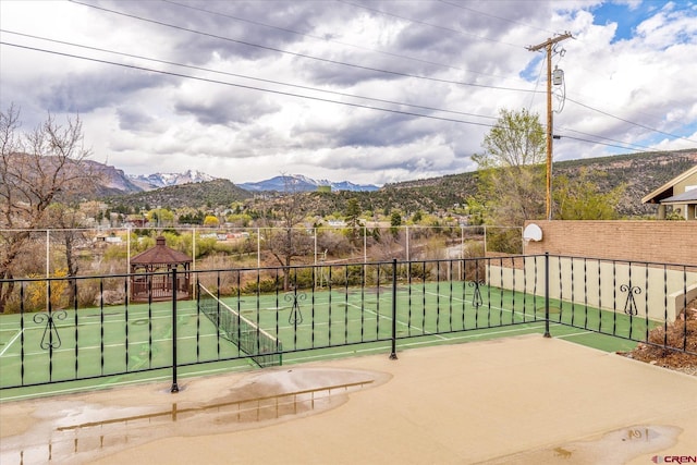 view of patio / terrace featuring fence, a gazebo, and a mountain view