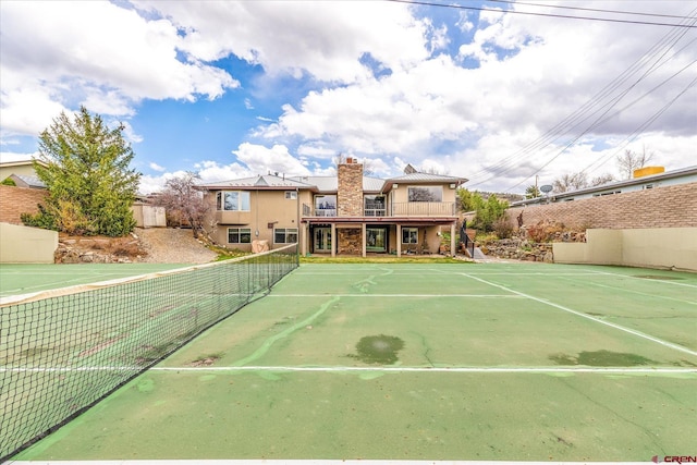 view of tennis court featuring fence
