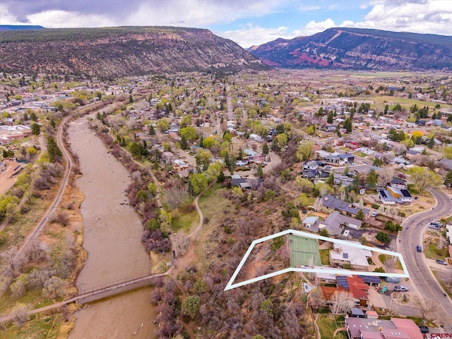 drone / aerial view featuring a residential view and a mountain view