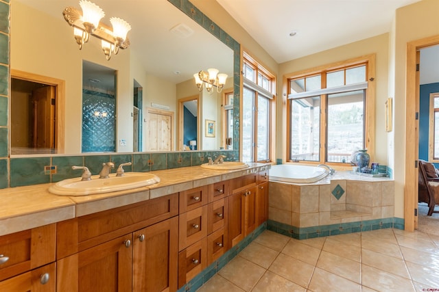 138 Silver Sage Dr, Crested Butte, CO 81224 - bathroom featuring tile patterned flooring, a garden tub, a sink, and a notable chandelier