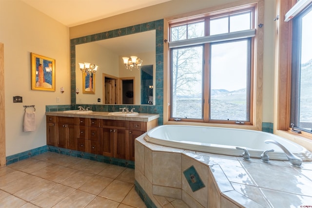 138 Silver Sage Dr, Crested Butte, CO 81224 - full bath featuring a garden tub, a sink, tile patterned floors, double vanity, and a notable chandelier