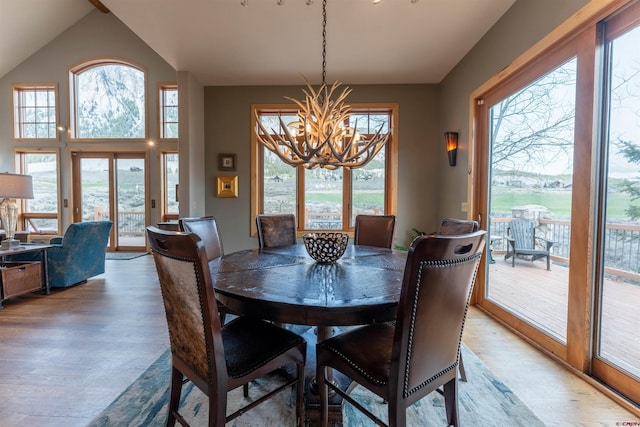 138 Silver Sage Dr, Crested Butte, CO 81224 - dining room featuring an inviting chandelier, lofted ceiling, and light wood finished floors