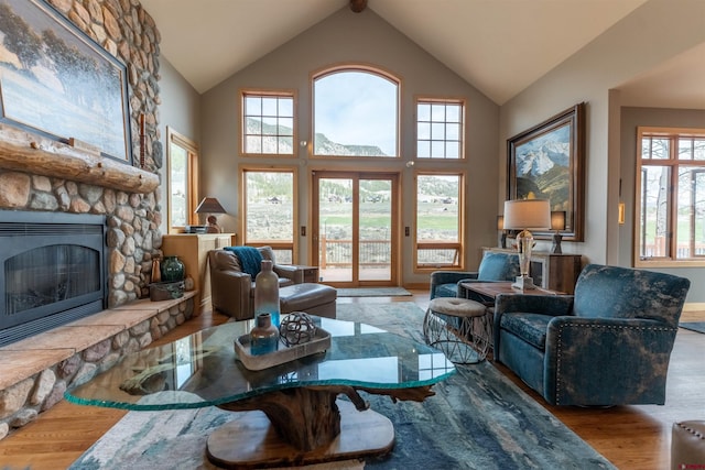 138 Silver Sage Dr, Crested Butte, CO 81224 - living area with wood finished floors, high vaulted ceiling, and a stone fireplace