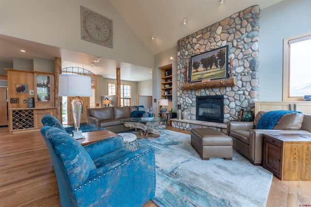 138 Silver Sage Dr, Crested Butte, CO 81224 - living area with a stone fireplace, wood finished floors, and high vaulted ceiling