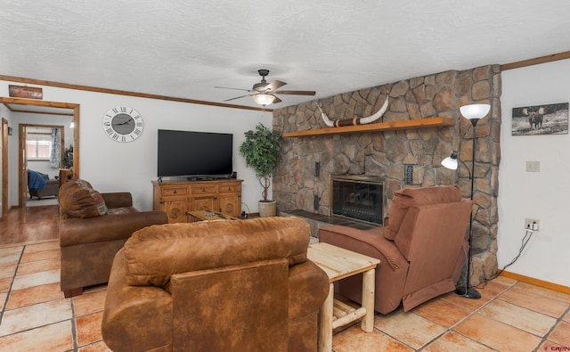 living area featuring a fireplace, a textured ceiling, a ceiling fan, and baseboards