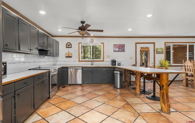 kitchen featuring recessed lighting, under cabinet range hood, light countertops, a ceiling fan, and appliances with stainless steel finishes