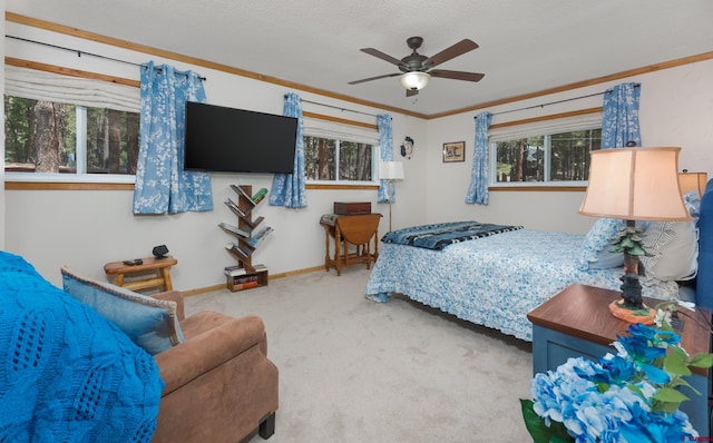carpeted bedroom featuring baseboards, ornamental molding, and multiple windows
