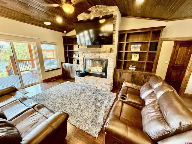 living area with a fireplace, lofted ceiling, wood ceiling, and wood finished floors