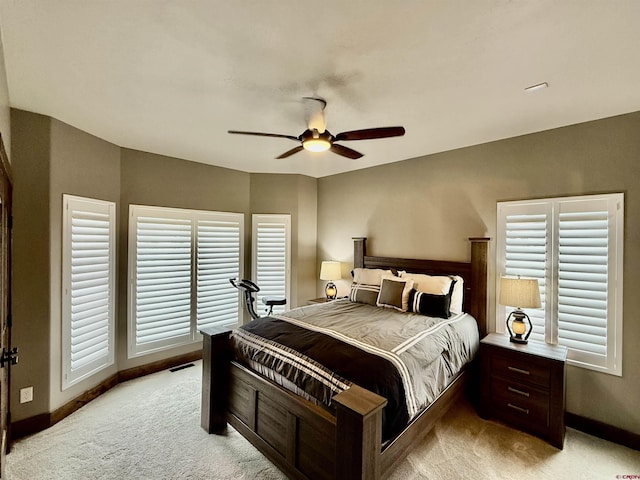 bedroom with ceiling fan, baseboards, and light carpet