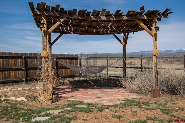 view of yard with a pergola and fence