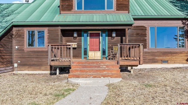 entrance to property with crawl space and metal roof