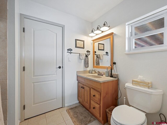 bathroom featuring toilet, vanity, and tile patterned floors
