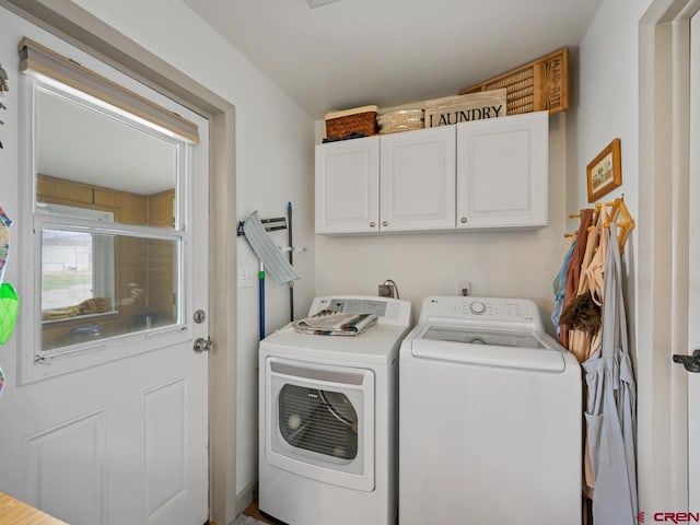 laundry area featuring washer and clothes dryer and cabinet space